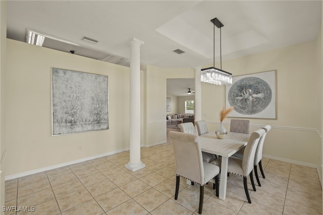 tiled dining space featuring ornate columns and ceiling fan