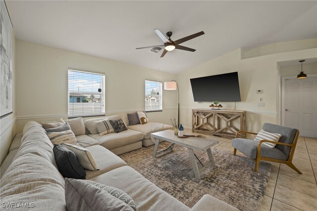 living room featuring light tile patterned floors, ceiling fan, and lofted ceiling