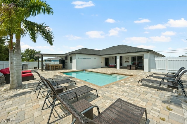 view of swimming pool with exterior bar and a patio area