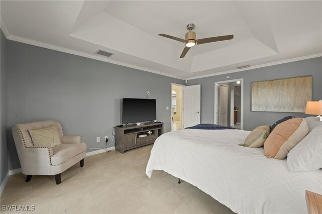 bedroom featuring connected bathroom, ceiling fan, crown molding, a tray ceiling, and light tile patterned floors