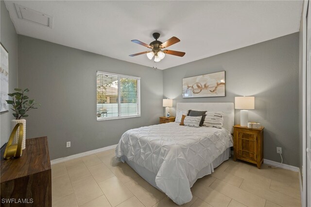 tiled bedroom featuring ceiling fan