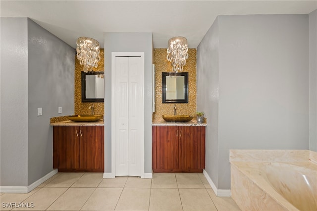 bathroom featuring backsplash, tile patterned flooring, vanity, and an inviting chandelier