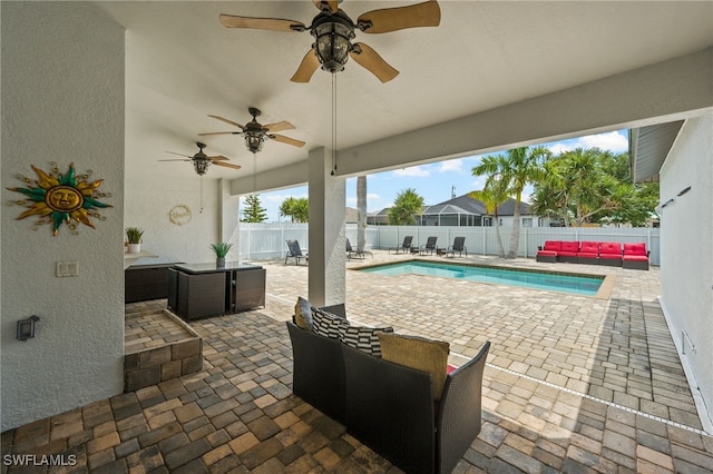 view of patio / terrace featuring a fenced in pool and an outdoor living space