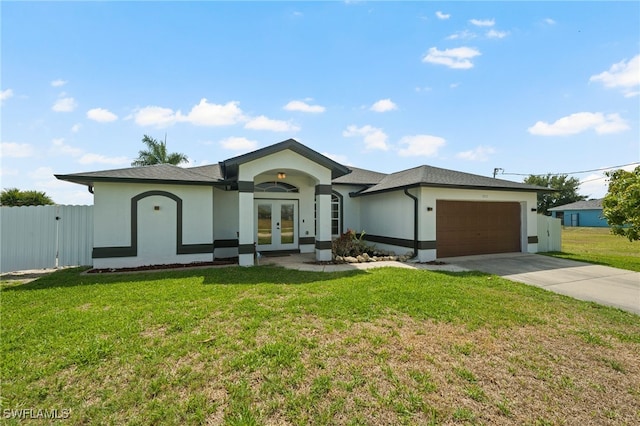 single story home with a front yard, french doors, and a garage