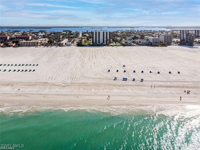 birds eye view of property featuring a water view and a beach view