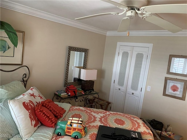 bedroom featuring a closet, ceiling fan, and crown molding