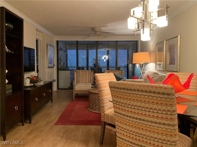 living room featuring ceiling fan with notable chandelier, crown molding, and light hardwood / wood-style flooring