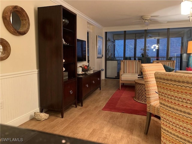 living room with ceiling fan, light hardwood / wood-style floors, and crown molding