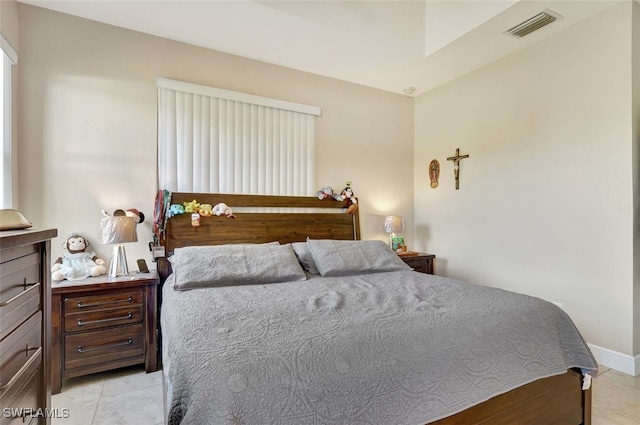 bedroom with light tile patterned floors