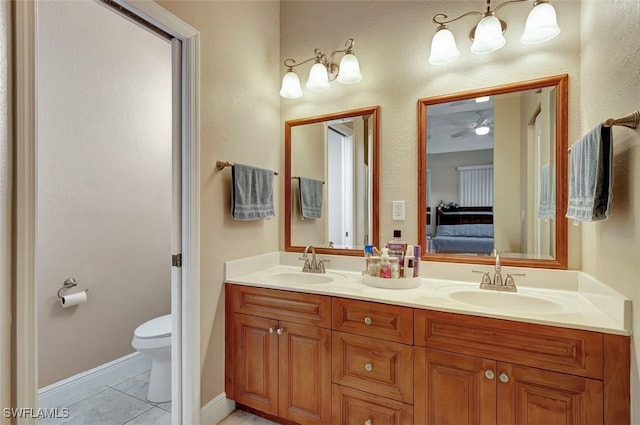 bathroom featuring vanity, ceiling fan, tile patterned floors, and toilet