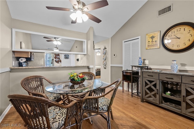 dining area with lofted ceiling, ceiling fan, and light hardwood / wood-style flooring