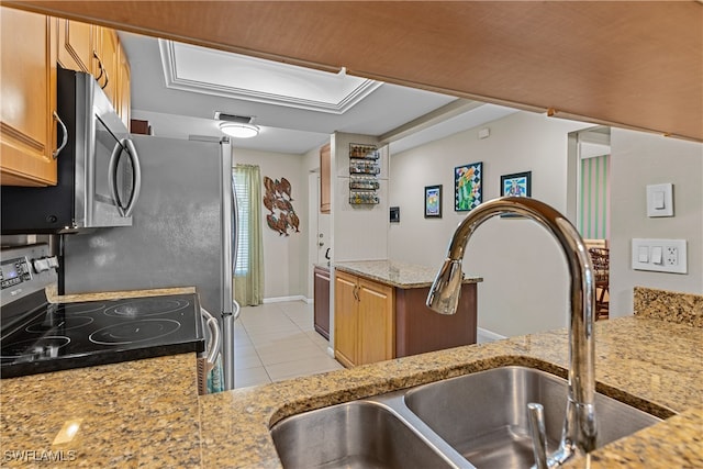 kitchen with black range with electric cooktop, sink, light tile patterned floors, and light stone counters