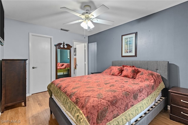 bedroom with ceiling fan and light hardwood / wood-style flooring