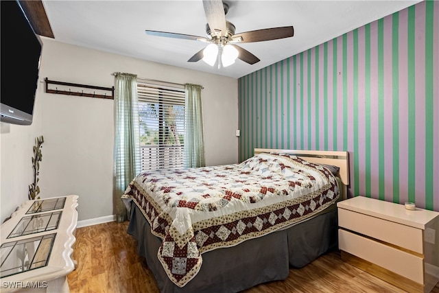 bedroom with ceiling fan and hardwood / wood-style flooring