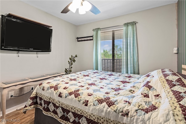 bedroom with ceiling fan and hardwood / wood-style flooring