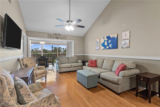 living room featuring ceiling fan, light hardwood / wood-style flooring, and high vaulted ceiling