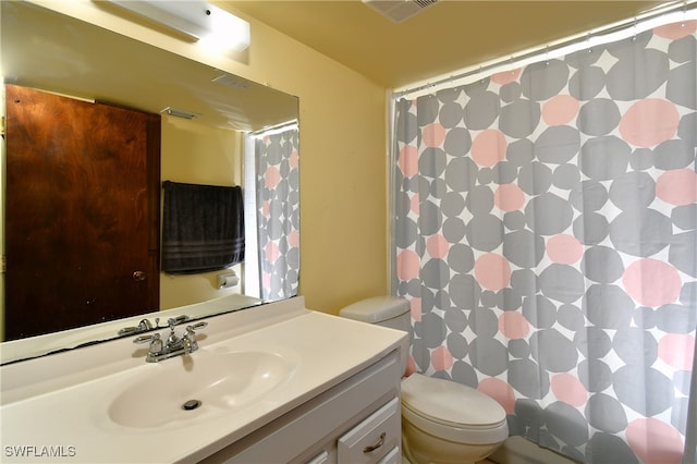 bathroom featuring vanity, toilet, and a shower with curtain