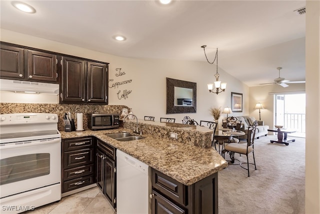 kitchen with ceiling fan with notable chandelier, white appliances, kitchen peninsula, and sink