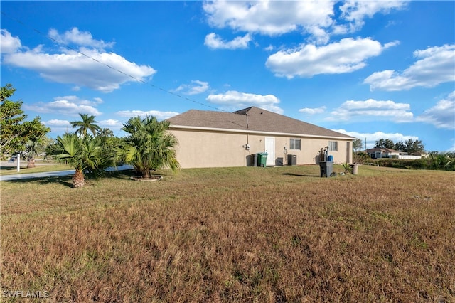 back of property with a lawn