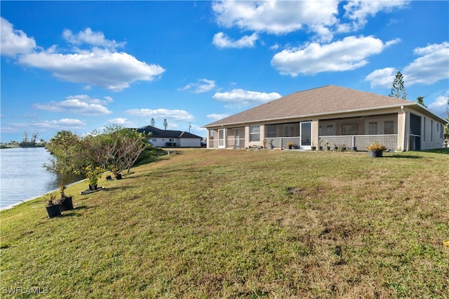 view of yard with a water view and a sunroom