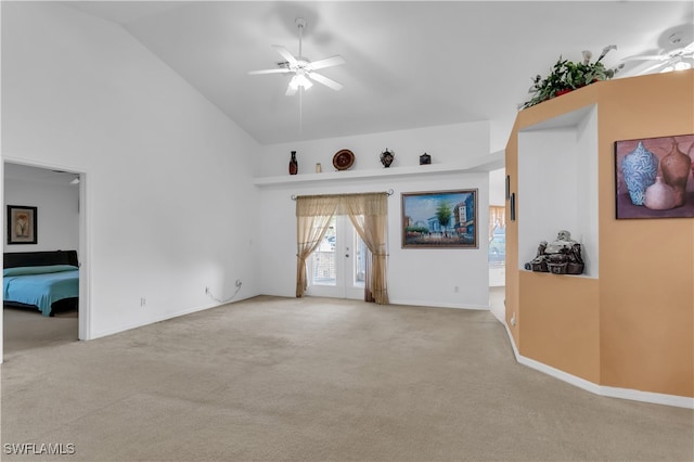 unfurnished living room featuring ceiling fan, light colored carpet, and high vaulted ceiling