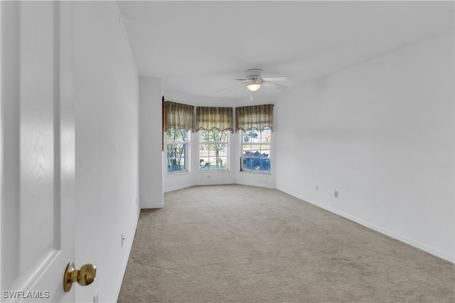 carpeted empty room with ceiling fan