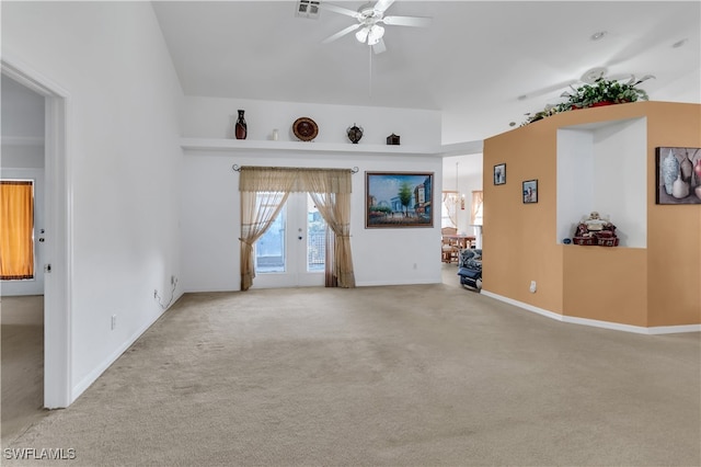 unfurnished living room featuring french doors, light carpet, and ceiling fan