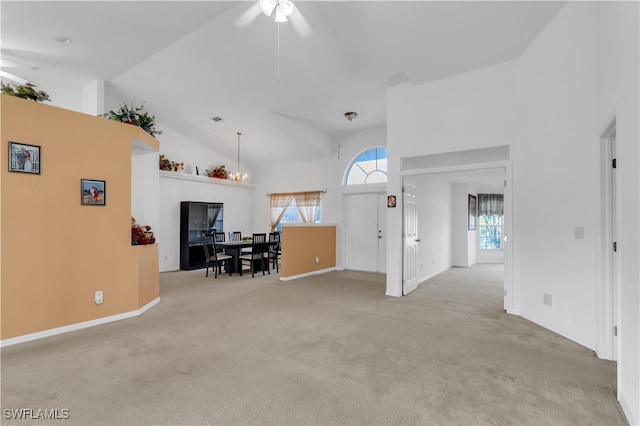 interior space featuring high vaulted ceiling, light carpet, and ceiling fan