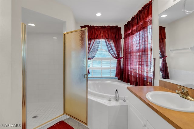 bathroom featuring independent shower and bath and vanity