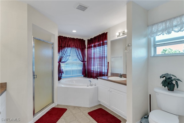 full bathroom featuring toilet, vanity, and separate shower and tub