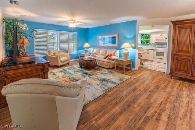 living room featuring ceiling fan and wood-type flooring