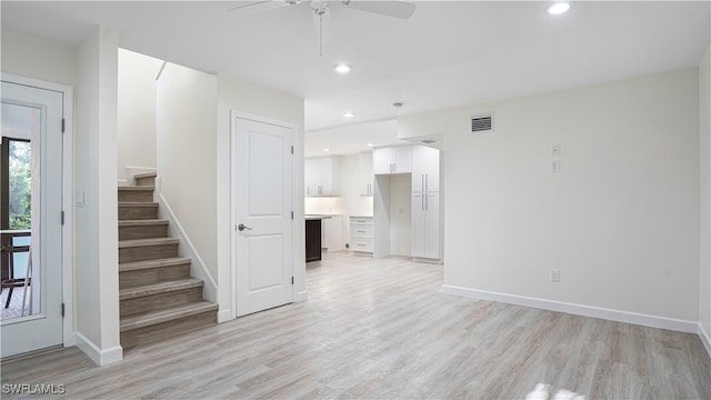 unfurnished living room with light wood finished floors, stairs, visible vents, and recessed lighting