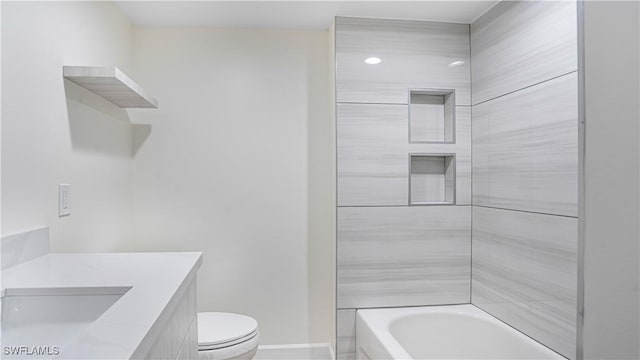 full bath with toilet, baseboards,  shower combination, and vanity