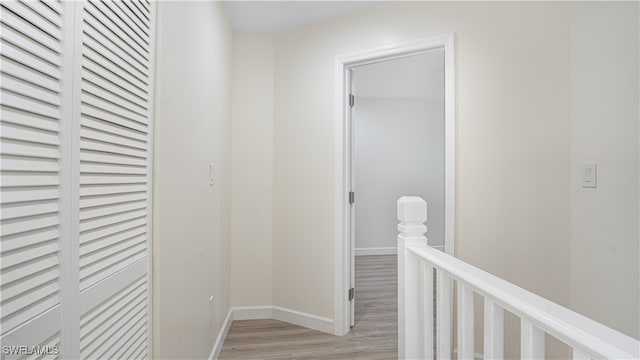 corridor with light wood-type flooring