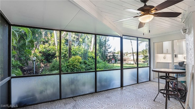 unfurnished sunroom featuring ceiling fan