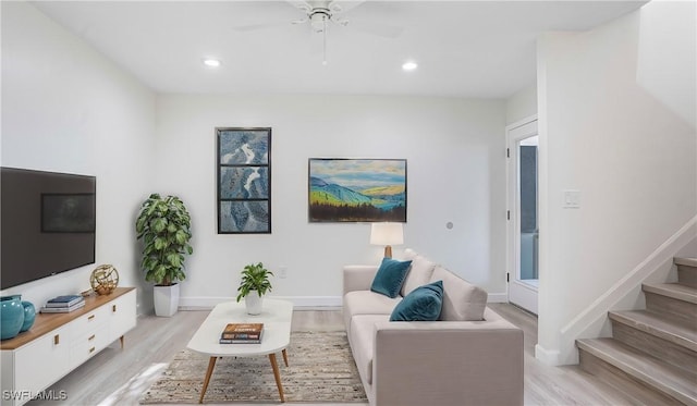 living area featuring light wood-style floors, recessed lighting, stairway, and baseboards