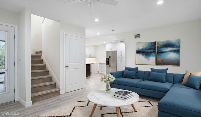 living area with visible vents, ceiling fan, stairway, light wood-style floors, and recessed lighting