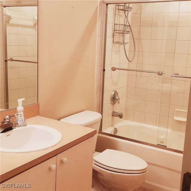 full bathroom with tiled shower / bath, vanity, and toilet