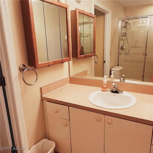 bathroom with vanity and a shower with shower door