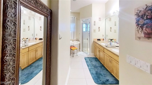 bathroom featuring tile patterned floors, vanity, and a bathing tub