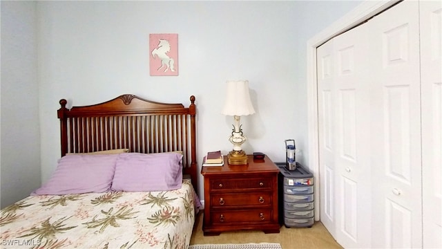 carpeted bedroom featuring a closet