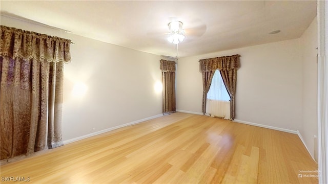 spare room featuring hardwood / wood-style floors and ceiling fan