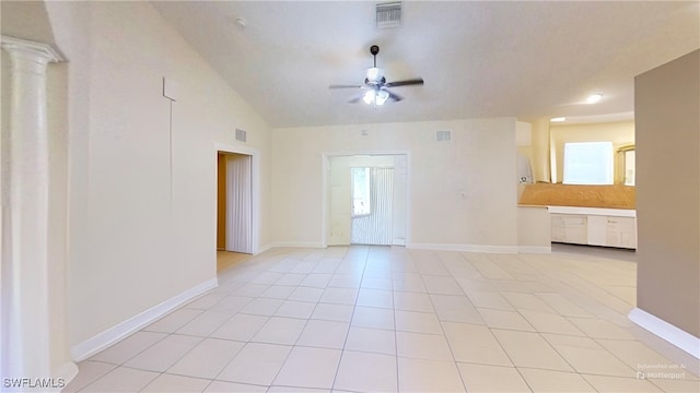 tiled spare room with ceiling fan and vaulted ceiling