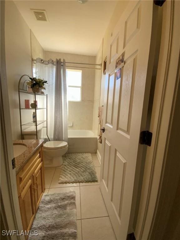 full bathroom with tile patterned flooring, shower / bath combo, vanity, and toilet