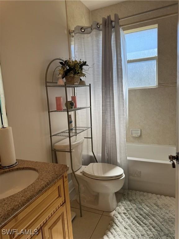 full bathroom with vanity, tile patterned flooring, shower / bathtub combination with curtain, and toilet