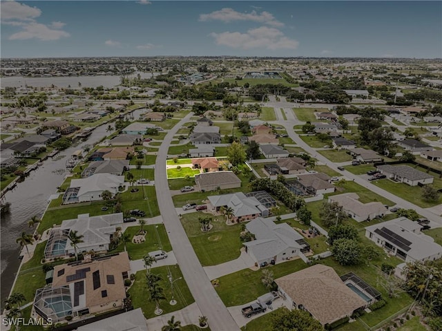 drone / aerial view with a residential view and a water view