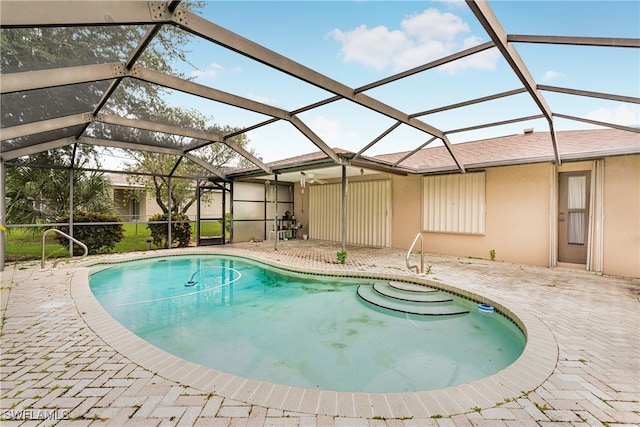 outdoor pool featuring a lanai and a patio