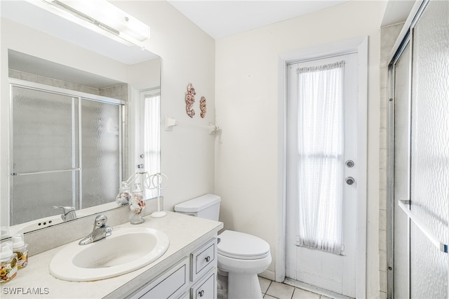 full bath with plenty of natural light, vanity, toilet, and a shower stall