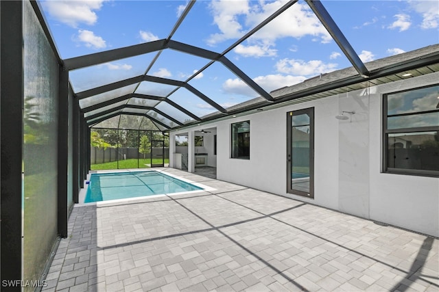 view of pool with a patio and glass enclosure