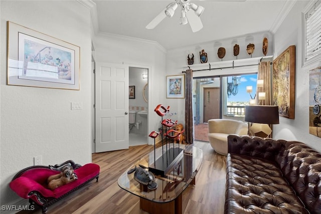 living area featuring wood finished floors, a ceiling fan, and ornamental molding